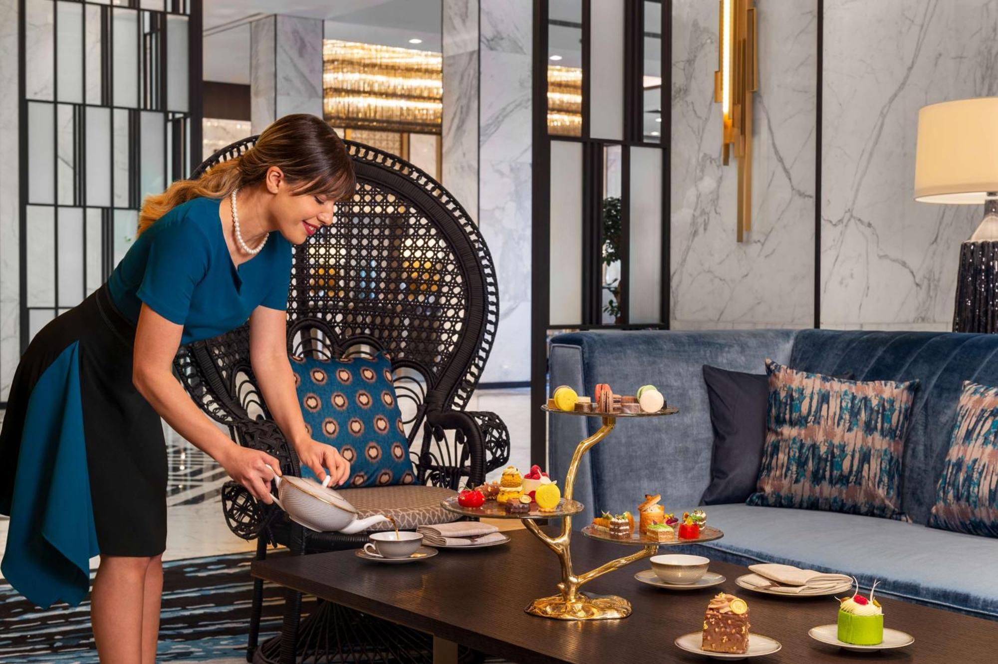 Waldorf Astoria Kuwait Hotel Kuwait City Bagian luar foto A hotel staff setting up a table